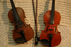 Violins with bows and music