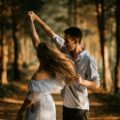 man and woman dancing at center of trees
